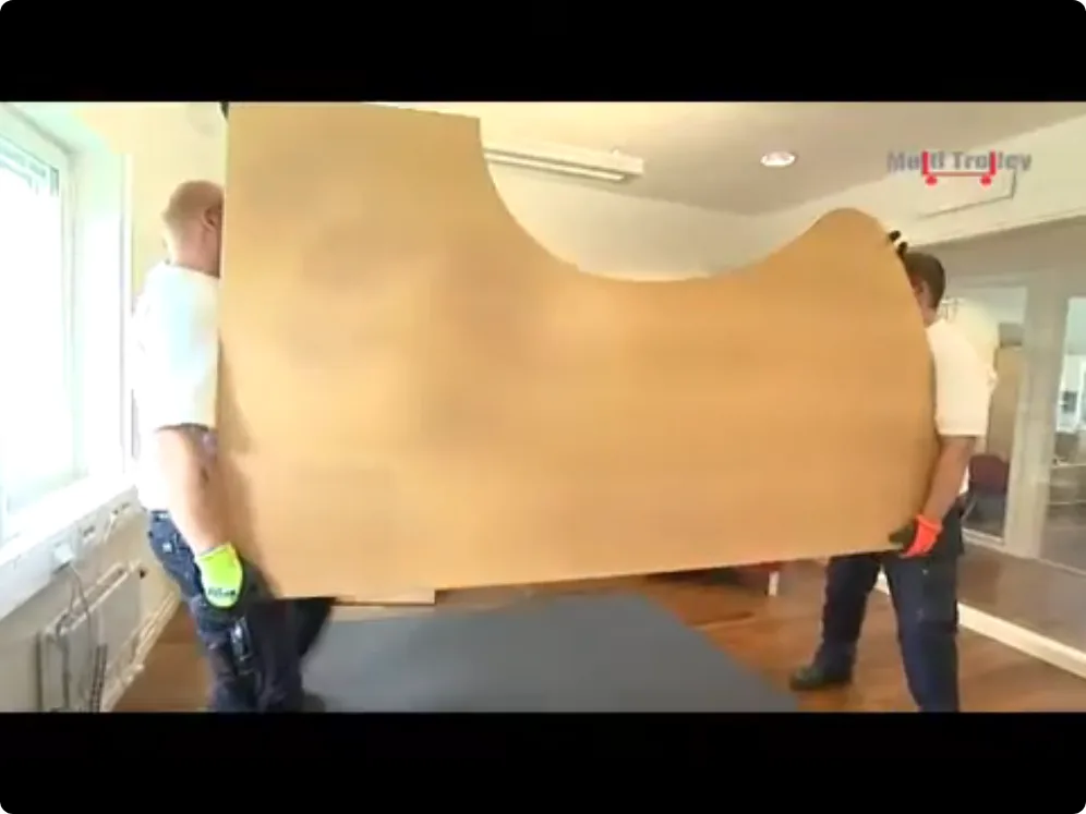 Movers preparing household items for transport